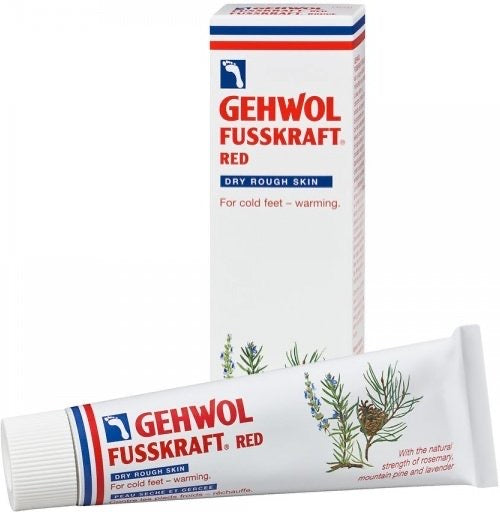 Tube og eske med fotkrem i hvitt bilde.foto
